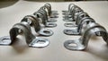 An industrial fixture clips or clamps.