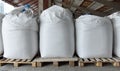 Industrial flour bags in the warehouse of the processing plant .