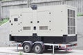 Industrial generator power. Mobile diesel backup generator on caravan wheels. Backup power supply generator for emergency