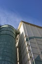 Industrial grain silos under a clear blue sky, showcasing modern architecture Royalty Free Stock Photo