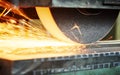 Industrial grinding. finishing metal surface on horizontal grinder machine Royalty Free Stock Photo