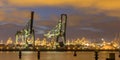 Industrial harbor landscape with two loading cranes at night Royalty Free Stock Photo