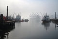 industrial harbor, with smoggy mist covering the water