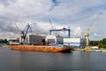 The industrial harbour in Rostock with a lot of cranes, heavy equipments and ships Royalty Free Stock Photo