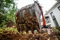 Industrial heavy duty excavator digging at construction site. Close-up of scoop and metal bucket