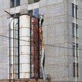 Industrial pipes from the end of the building, rusty old pipes on the side of the facade of the house Royalty Free Stock Photo