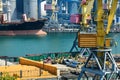 Industrial infrastructure of the seaport, the sea, cranes and railway wagons, grain silo, bulk carrier vessel and grain storage