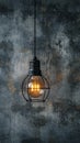 Industrial innovation hanging lightbulb on textured cement backdrop