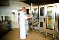 Industrial kitchen interior with busy cooks Royalty Free Stock Photo