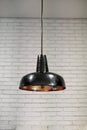 Industrial black lamp and white brick wall