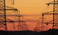 Electric furnace lines with towers on a sunset background