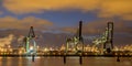 Industrial landscape with Harbor quay and loading cranes at nigh