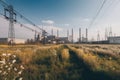 Industrial landscape with high voltage power lines and yellow flowers. Toned. Ecological electrical power plants all in one frame