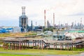 Industrial landscape. Panoramic view of the technological pipes. Plant settings. From the chemical red-white pipes smoke is coming