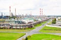 Industrial landscape. Panoramic view of the technological pipes. Plant settings. From the chemical red-white pipes smoke is coming