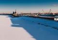 Industrial landscape with port cranes in docks. River port in winter