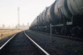 Industrial landscape. Rails and goods freight wagons of the train leaving for the horizon. Commercial transportation of cargo Royalty Free Stock Photo