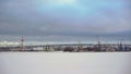 Industrial landscape. Sea port, port cranes. Winter, snow, frozen river or lake. Royalty Free Stock Photo