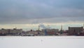 Industrial landscape. Sea port, port cranes. Winter, snow, frozen river or lake. Royalty Free Stock Photo