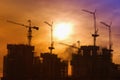 Industrial landscape with silhouettes of cranes Royalty Free Stock Photo