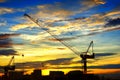 Industrial landscape with silhouettes of cranes on Royalty Free Stock Photo