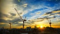 Industrial landscape with silhouettes of cranes on Royalty Free Stock Photo