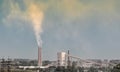 Industrial landscape smoke from the chimney of the plant and smog in the sky over the city in Ukraine Donbass Royalty Free Stock Photo