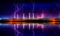 Industrial landscape with smoking chimneys and reflection in water at night Royalty Free Stock Photo