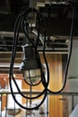 Industrial light fixture with cord hanging from ceiling