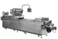 Industrial line for packaging of food products. Packing of bread at the factory.The machine for cutting and packing in a factory f