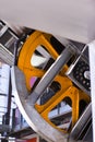 Industrial_Linkage_with_orange_flywheel_form_wheel_protective_metal_casing Royalty Free Stock Photo