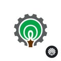 Industrial logo with stylized tree silhouette and gear around Royalty Free Stock Photo