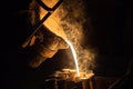 Industrial lost wax casting. The process of pouring for filling out ceramic shells with molten steel. Royalty Free Stock Photo