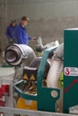 An industrial machine equipped with diamond discs is used to grind concrete floors to a smooth and even finish, preparing the