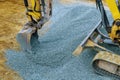 Industrial machinery construction site, excavator moving gravel and rocks for foundation building Royalty Free Stock Photo