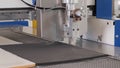 Waterjet cutting machine working on plastic foam sheet - close up