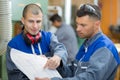 industrial manufacturing workers reading engineering blueprint Royalty Free Stock Photo