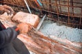 Industrial mason, bricklayer and construction worker using trowel and hands for building exterior brick walls Royalty Free Stock Photo