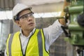 Industrial mechanics are working in front of a factory machine. Young technicians factory worker controlling the work Royalty Free Stock Photo