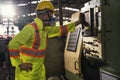 Industrial mechanics are working in front of a factory machine. Young technicians factory worker controlling the work Royalty Free Stock Photo