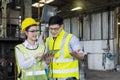 Industrial mechanics are working in front of a factory machine. Young technicians factory worker controlling the work Royalty Free Stock Photo