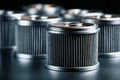 Industrial metal cylindrical filters with pleated surface texture arranged in a dark setting emphasizing mechanical components and Royalty Free Stock Photo