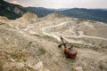 Industrial mining extraction site with big tracks on huge quarry.