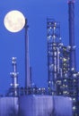 An industrial moonrise over a chemical plant
