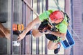 Industrial mountaineering worker cleaning window outside building. Royalty Free Stock Photo