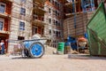 Industrial obsolete wheelbarrow placed on building site, area under construction, for logistics needs