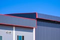 Industrial office building next to metal warehouse against blue clear sky background Royalty Free Stock Photo