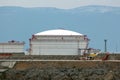 Industrial oil refinery tank on top of rocky hill