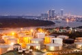 Industrial oil tanks in a refinery with building cityscape Royalty Free Stock Photo