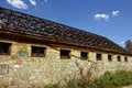 Industrial old abandoned warehouse with a dismantled wooden roof Royalty Free Stock Photo